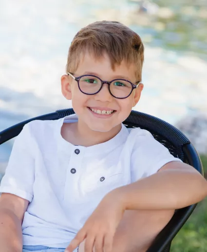 boy with glasses smiling